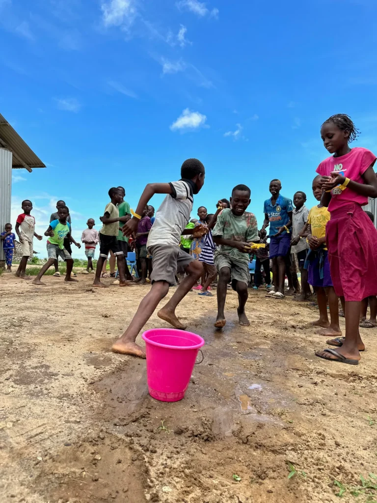 Children complete a team activity during camp