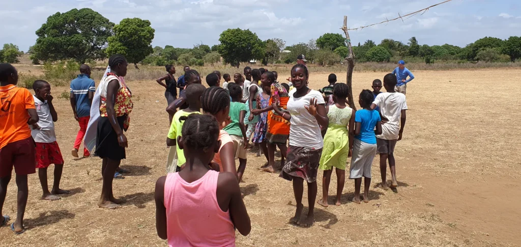Volunteers lead a game for children
