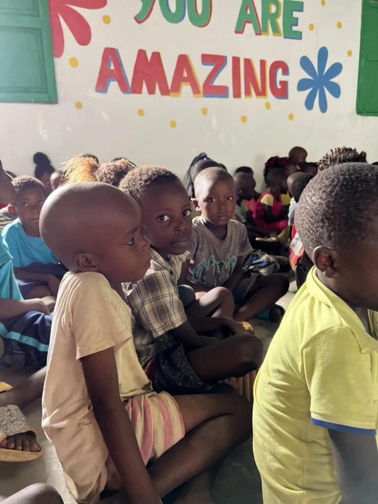 Children listen to a Bible story at camp