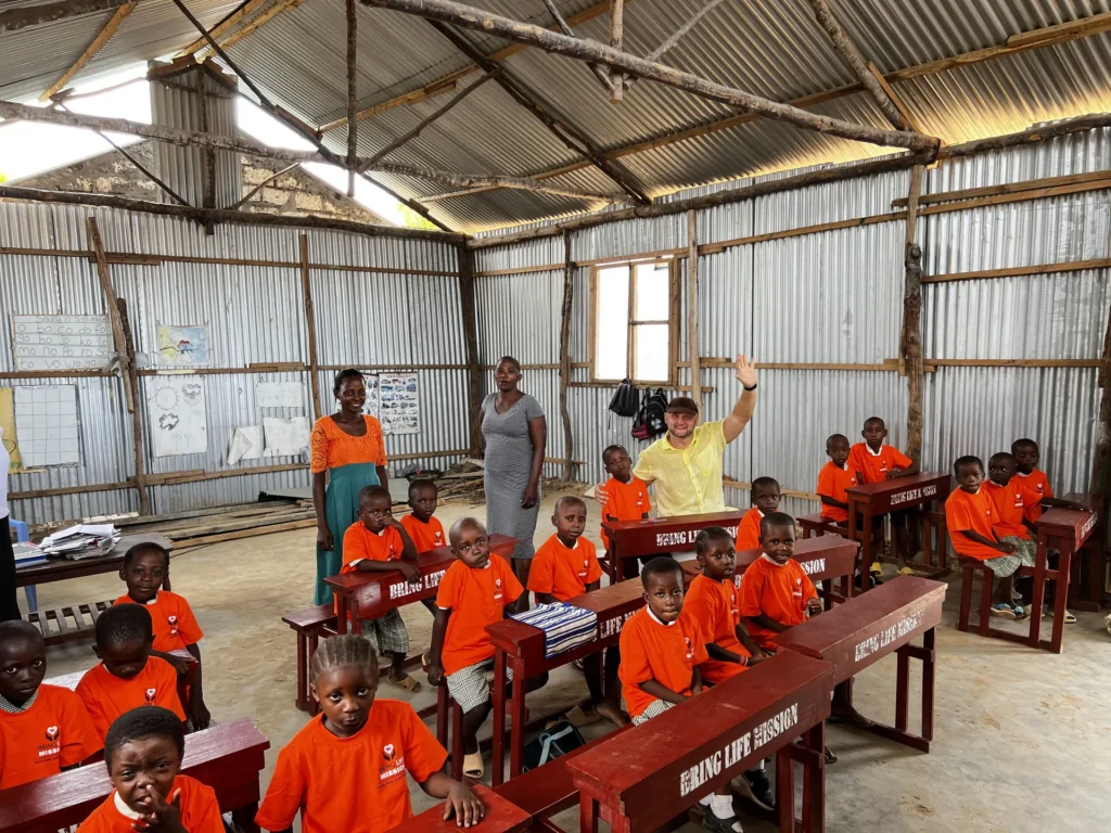 Children seated at desks in a classroom