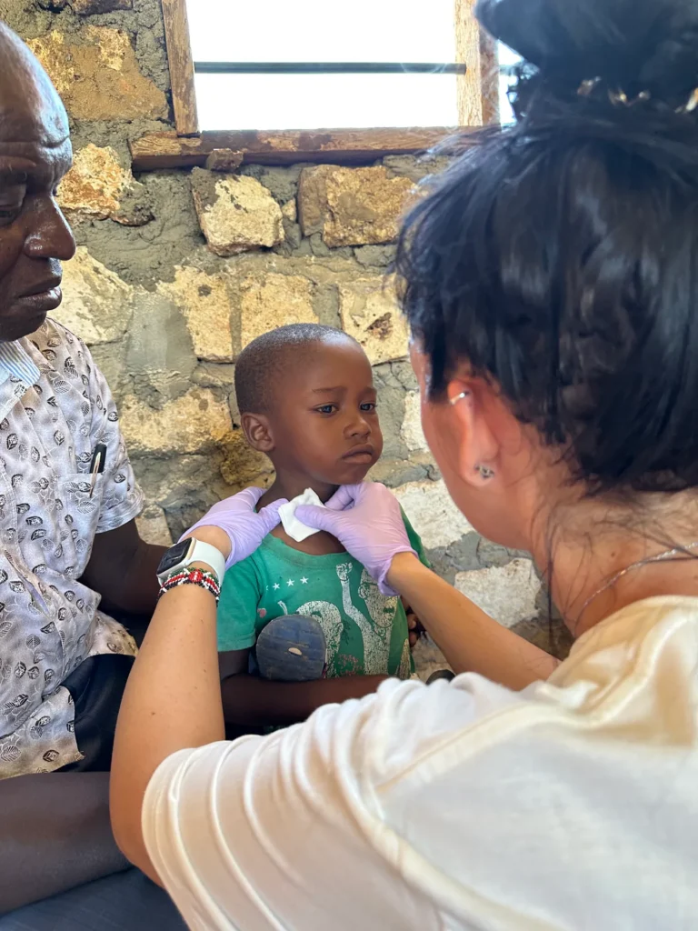 A child receives a medical examination in Kenya
