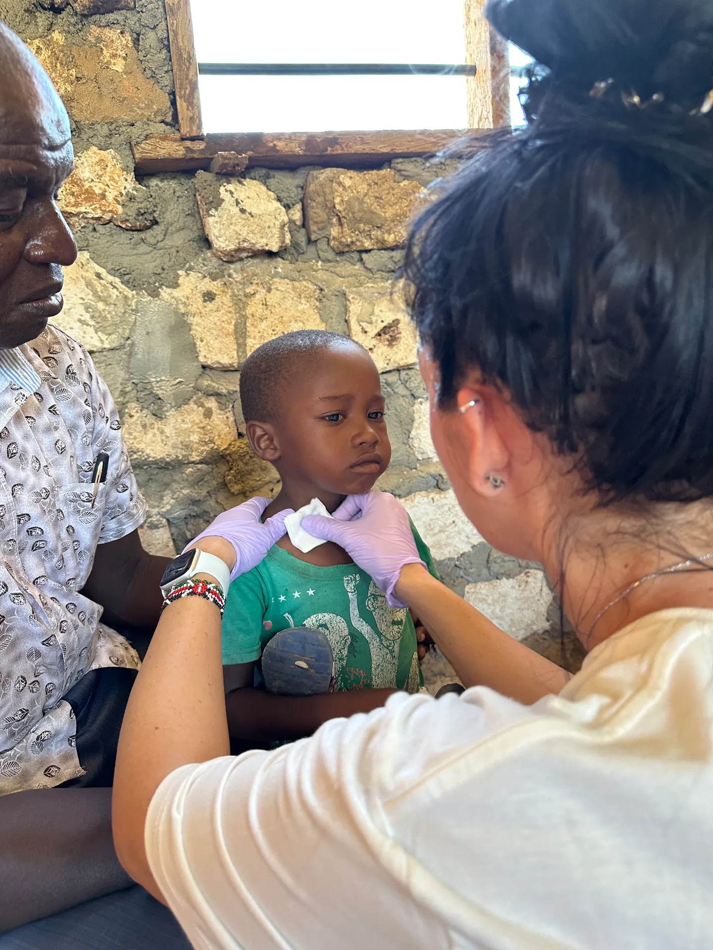 A child receives a medical examination in Kenya