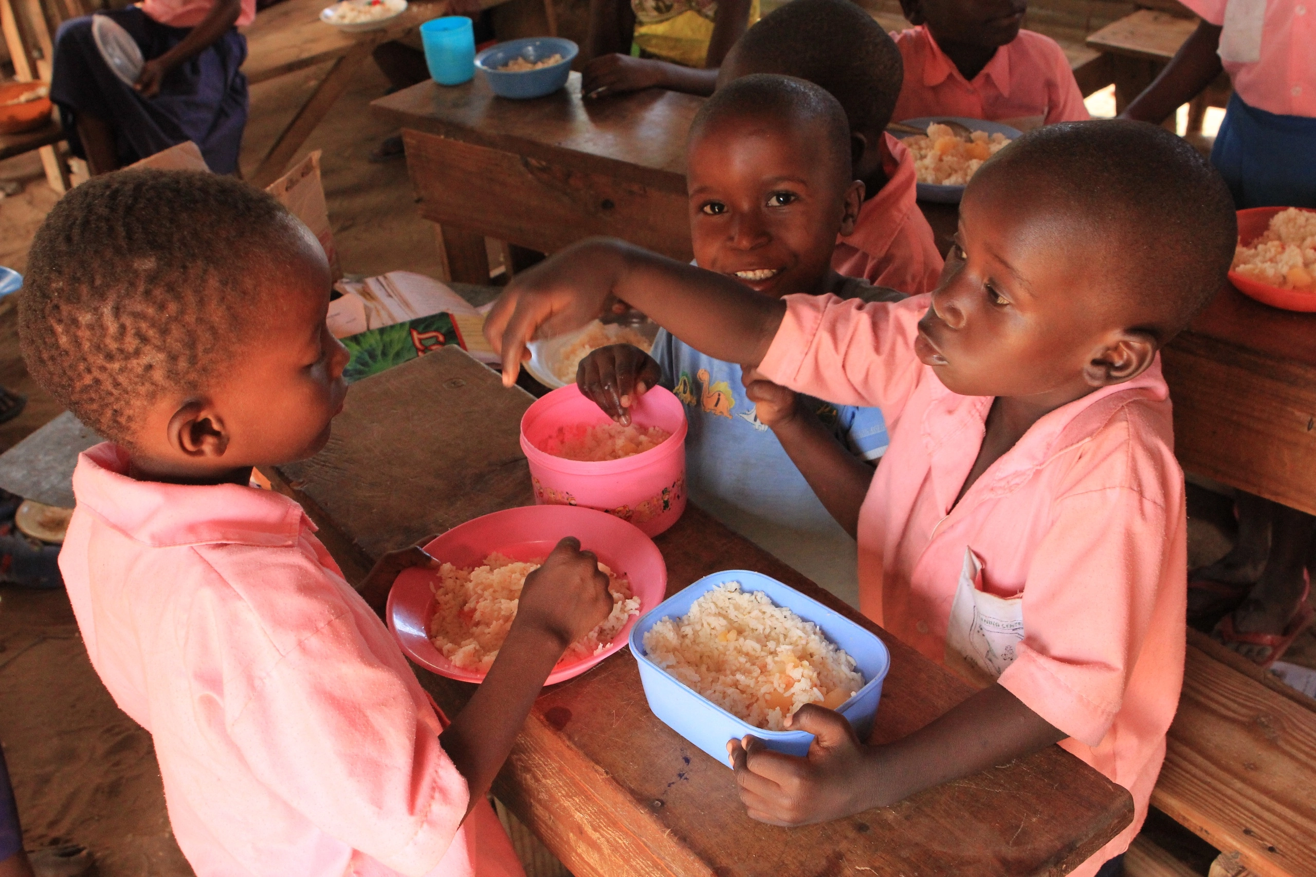 Children receive meals at the Bring Life Mission school