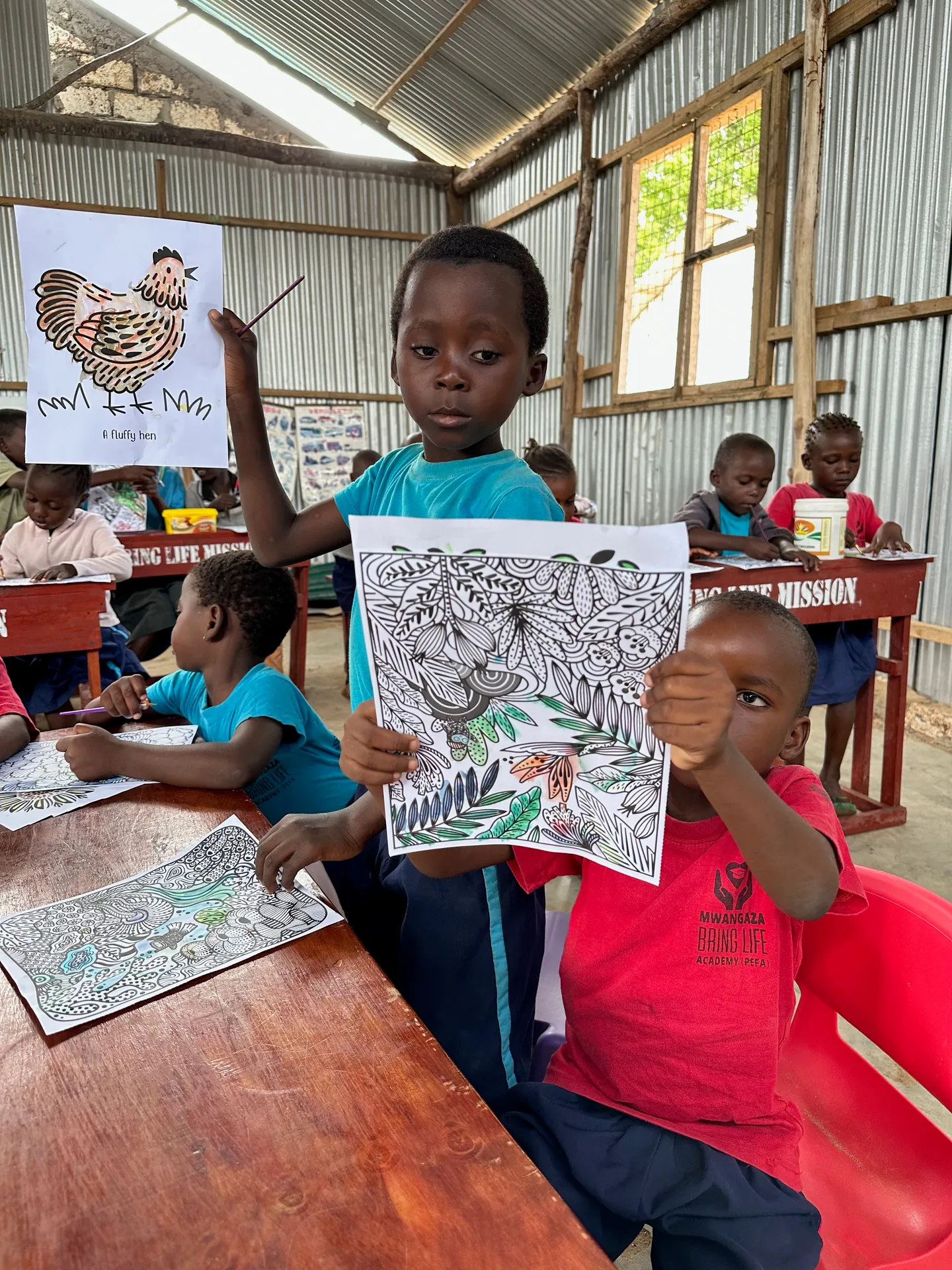 Children with drawings at a class