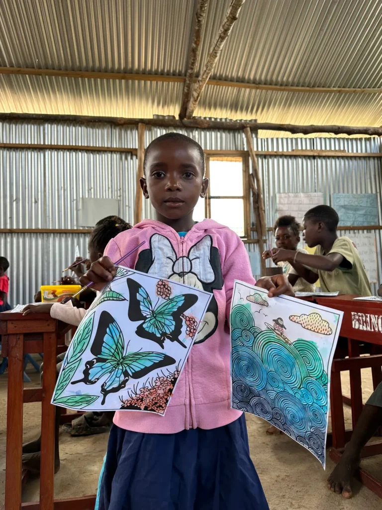 A child showing their drawing