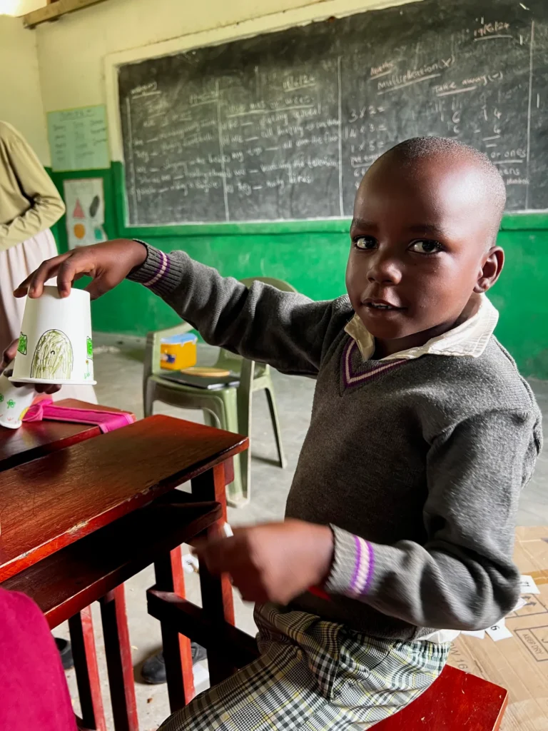 A child showing their drawing