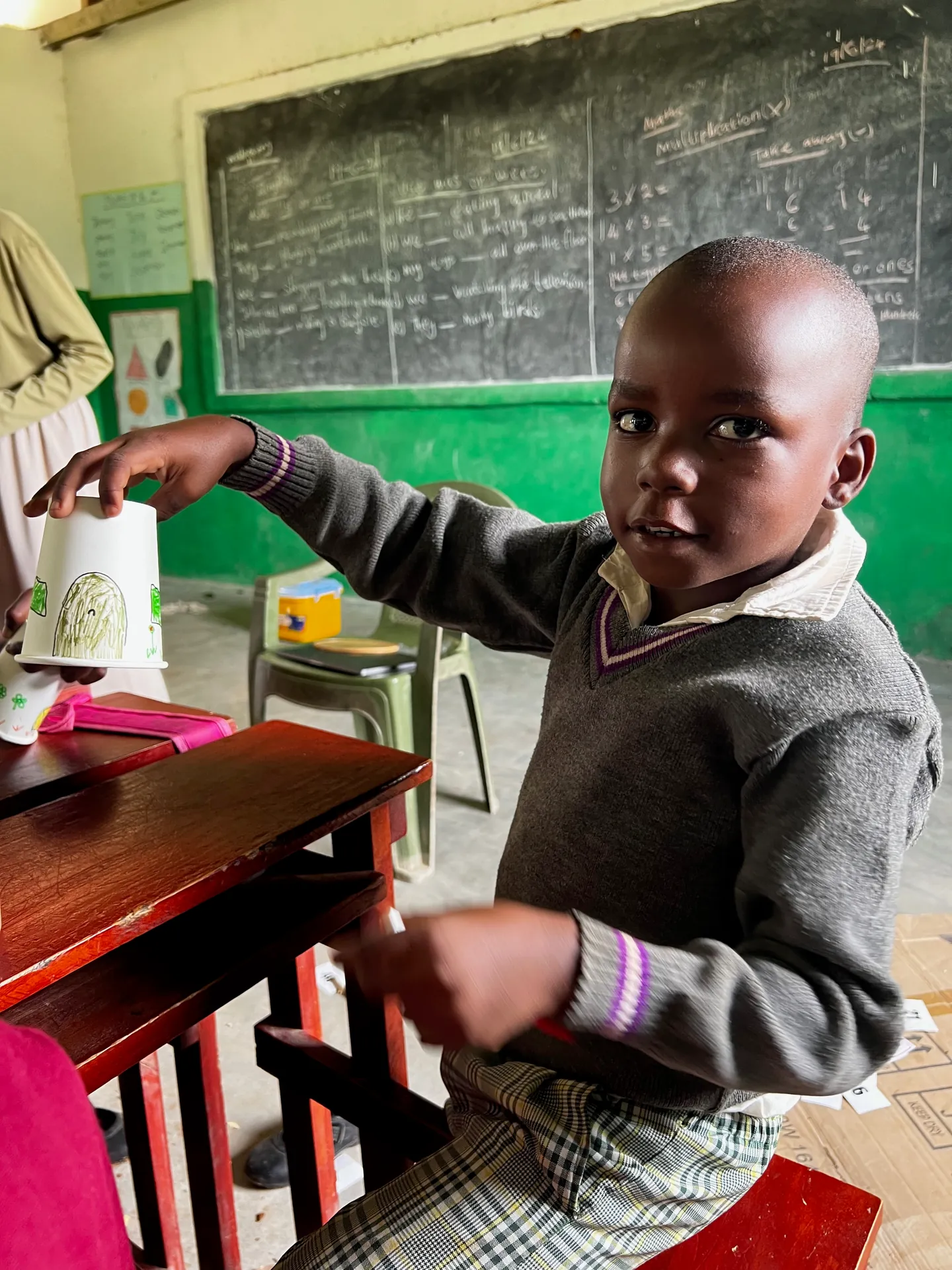 A child showing their drawing