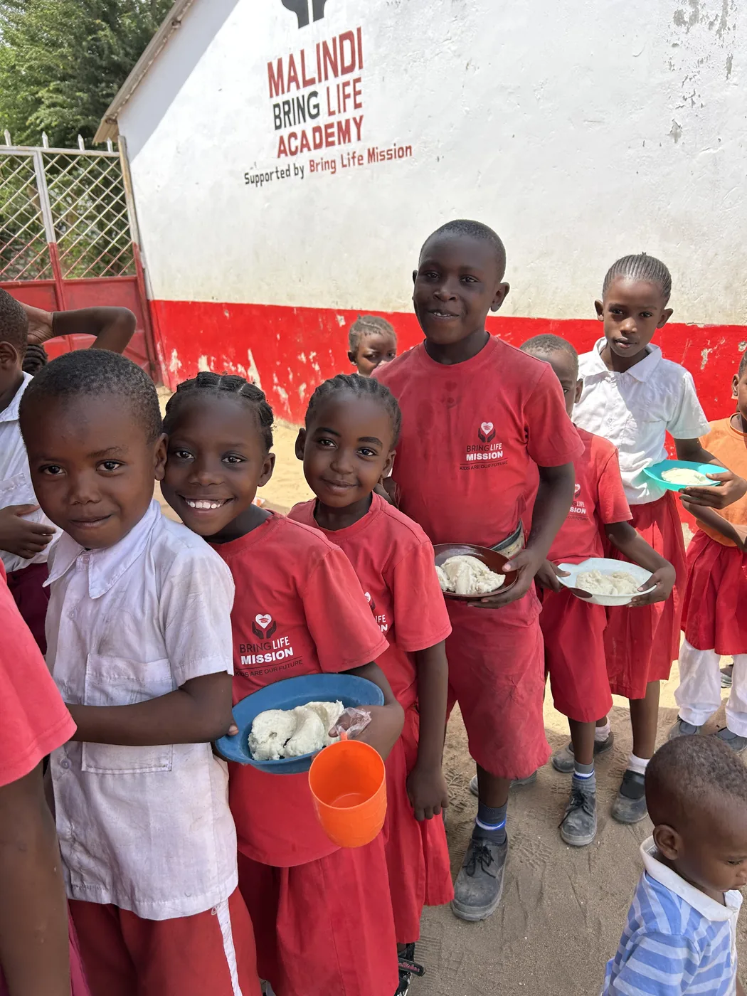 Malindi Bring Life Academy students line up for daily meals in the Furunzi settlement in Kenya