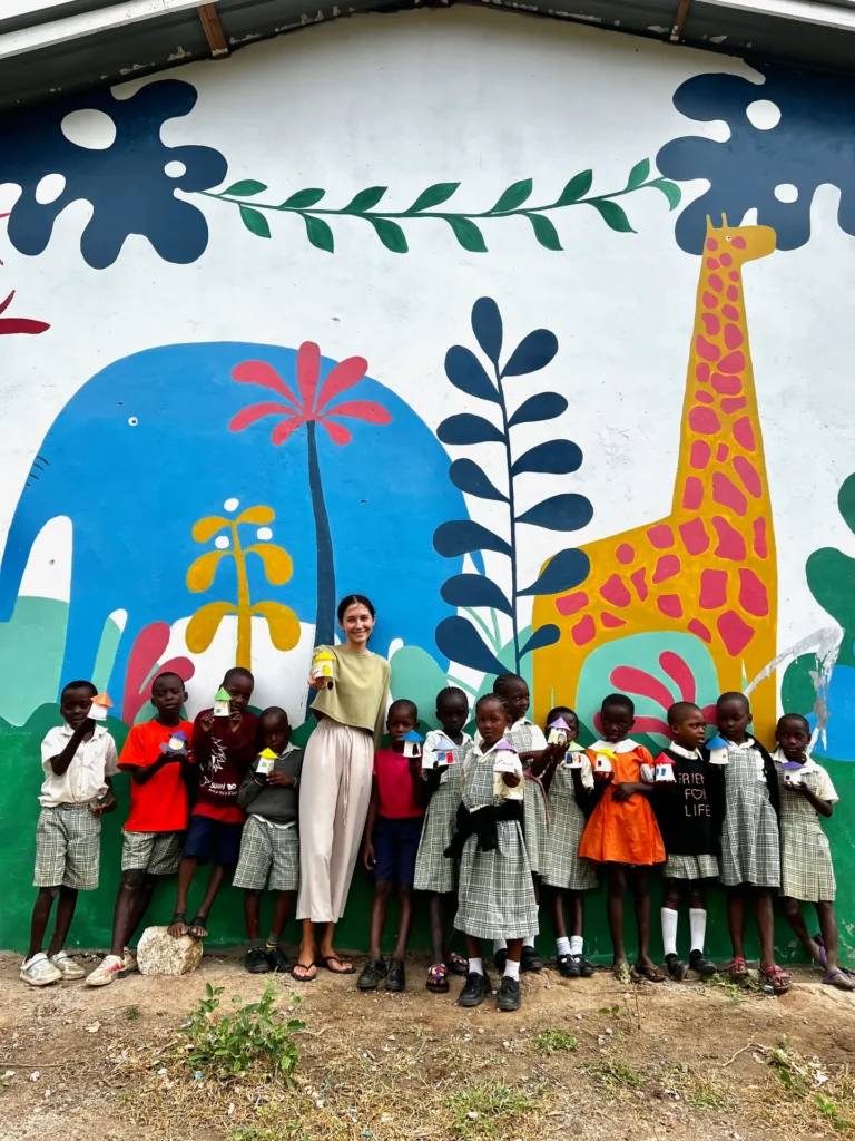 A child showing their drawing at a class