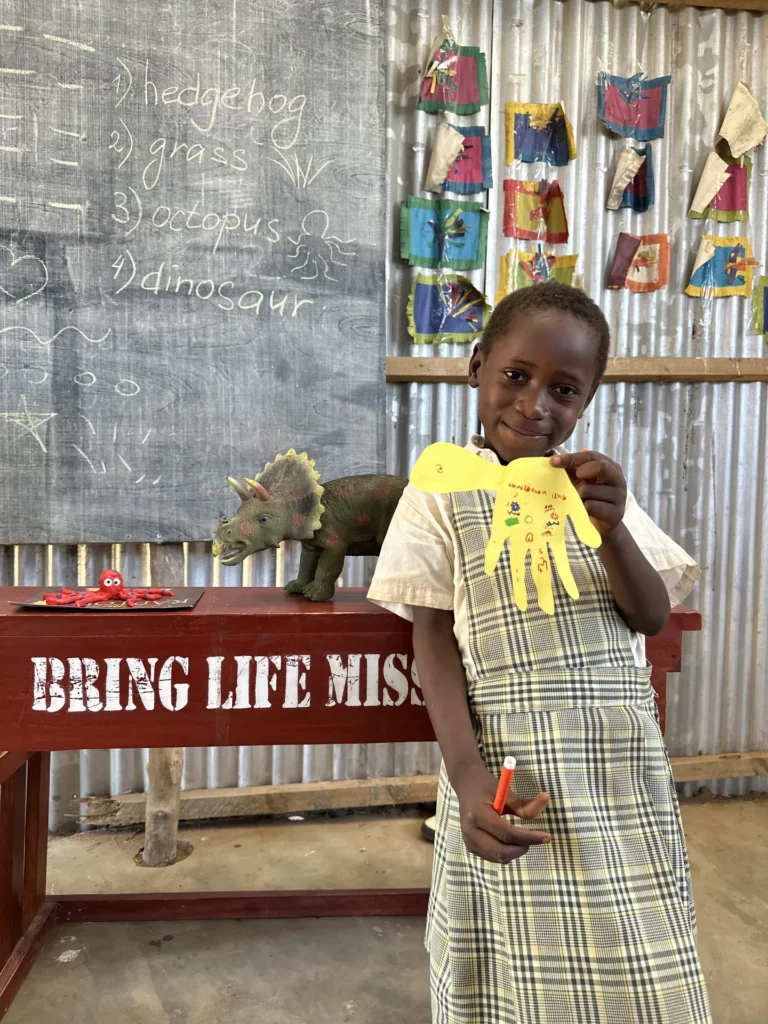 Children showing their crafts and drawings at a class