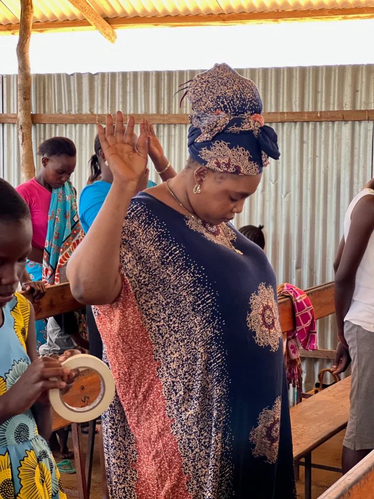 Hands raised in prayer and worship during a service