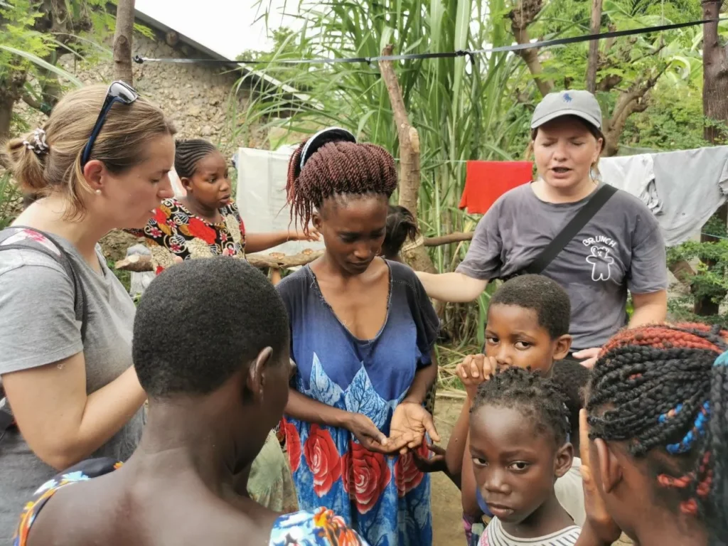 Missionaries pray for a young woman during family visits