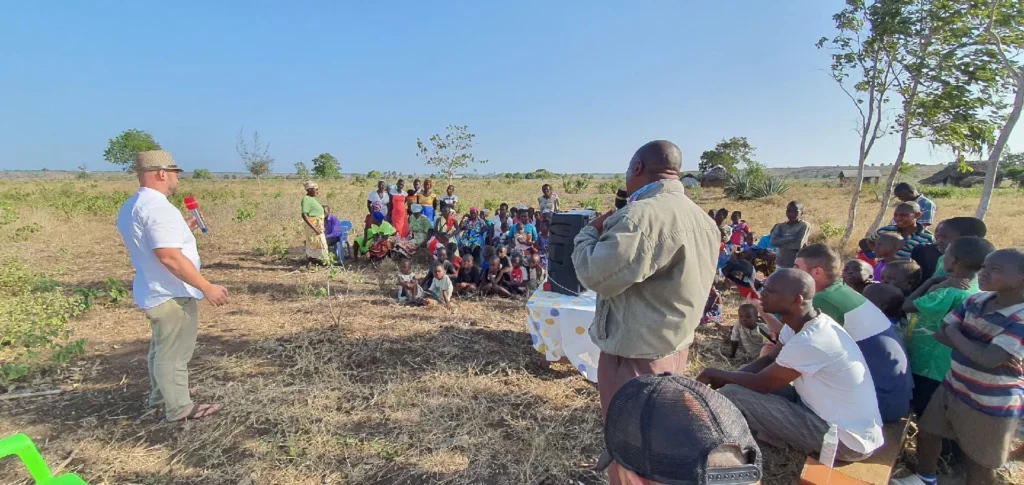 Dzianis Laptseikin preaches the Gospel to villagers out in an open field in Kenya