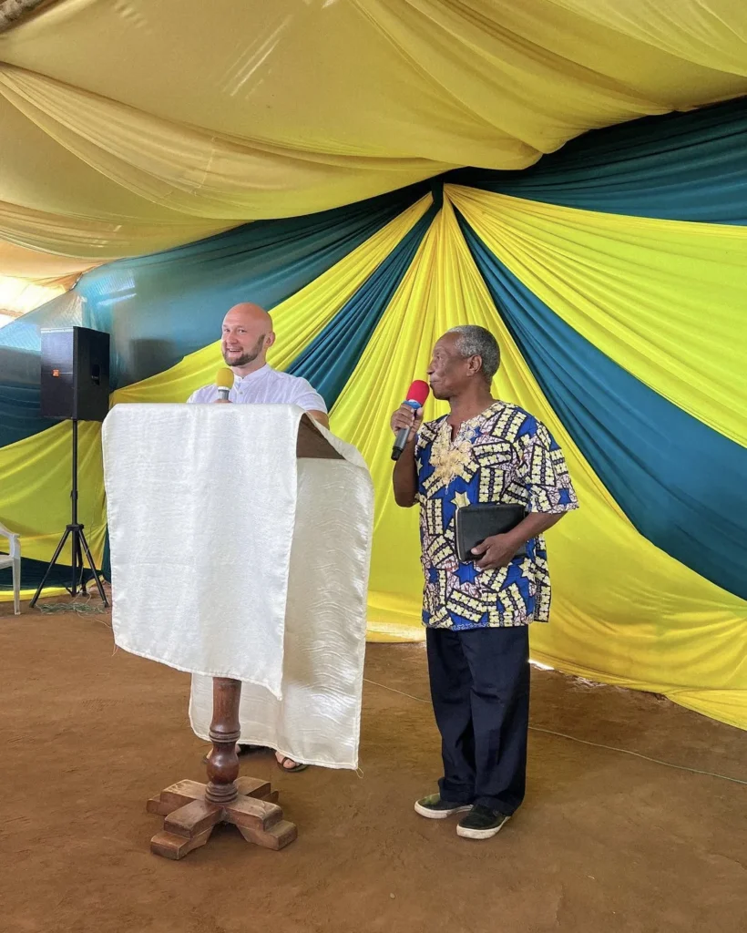 Preaching under a tent at a conference as a local pastor translates