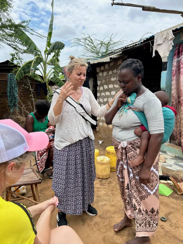 Praying together with families in the Furunzi slum
