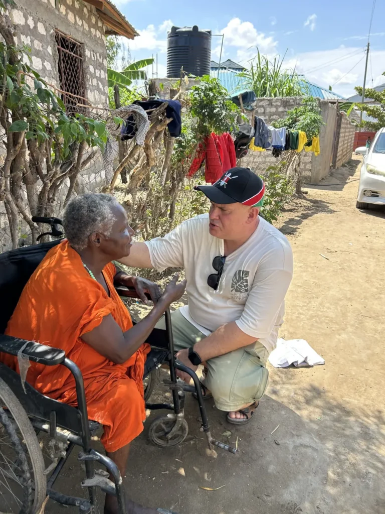 Pastor Dmitry Kovalinsky prays for a woman with a disability