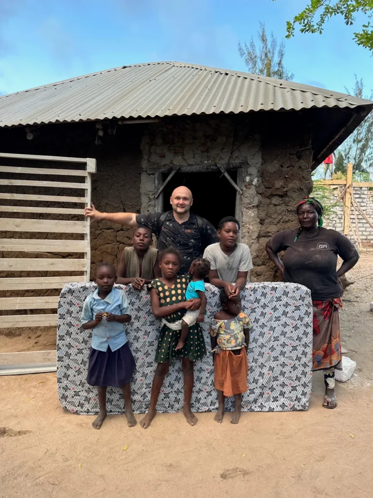 Dzianis Laptseikin with a large Kenyan family that received a bed and mattress from Bring Life Mission