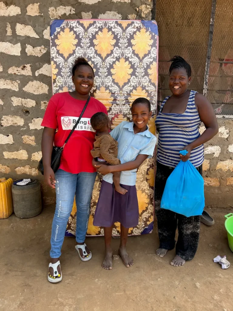 Caroline Njue delivers help to a mother with young children