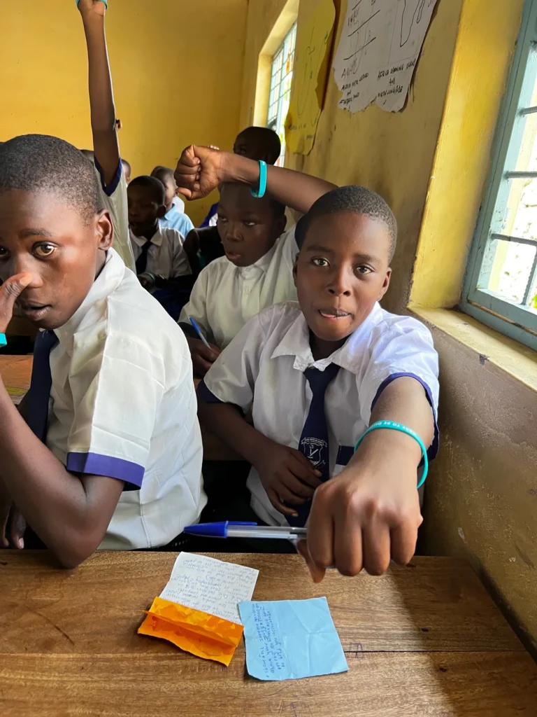 Teenagers listening to a speaker at a training