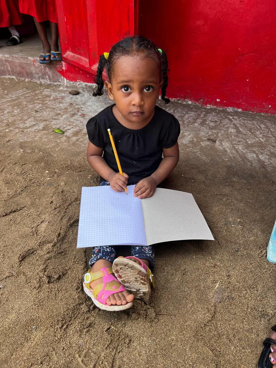 School supply kits including a notebook, pencils, and an eraser prepared for students in Furunzi