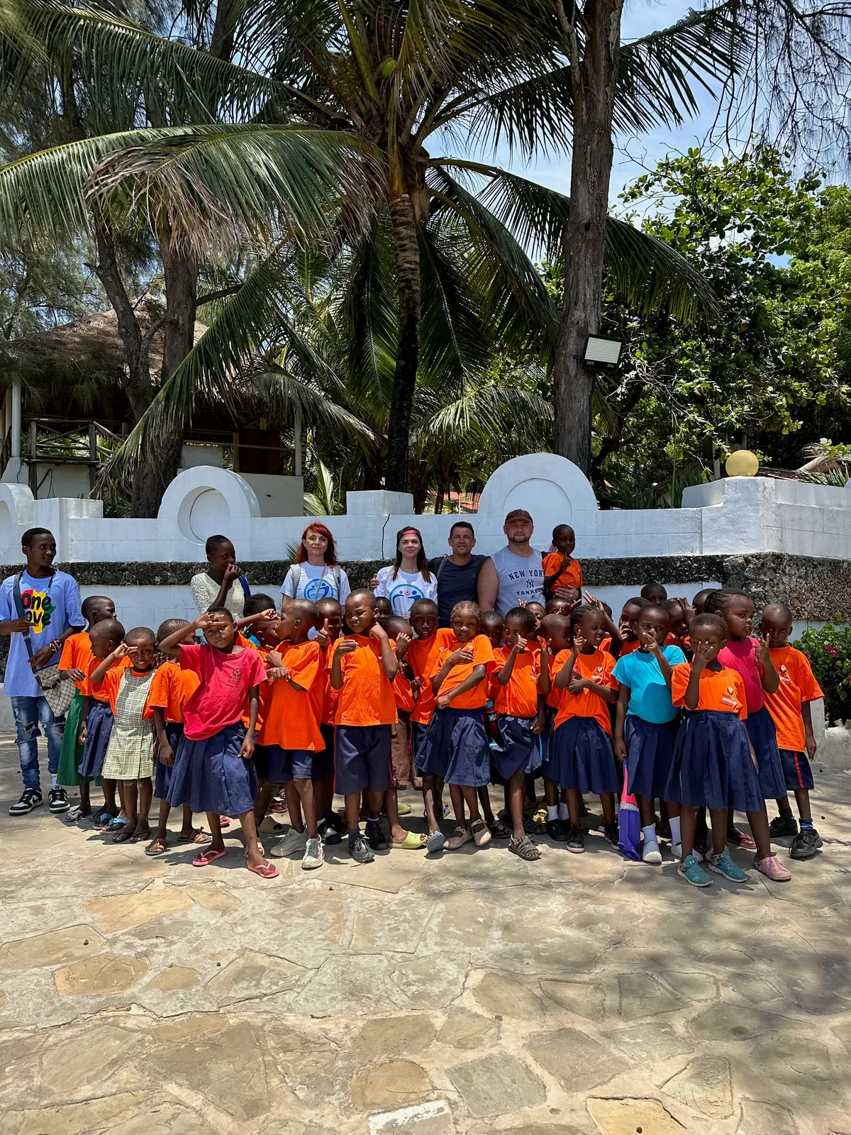 Students in new orange T-shirts from the mission