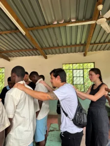 A team prays during a ministry visit at a juvenile detention center