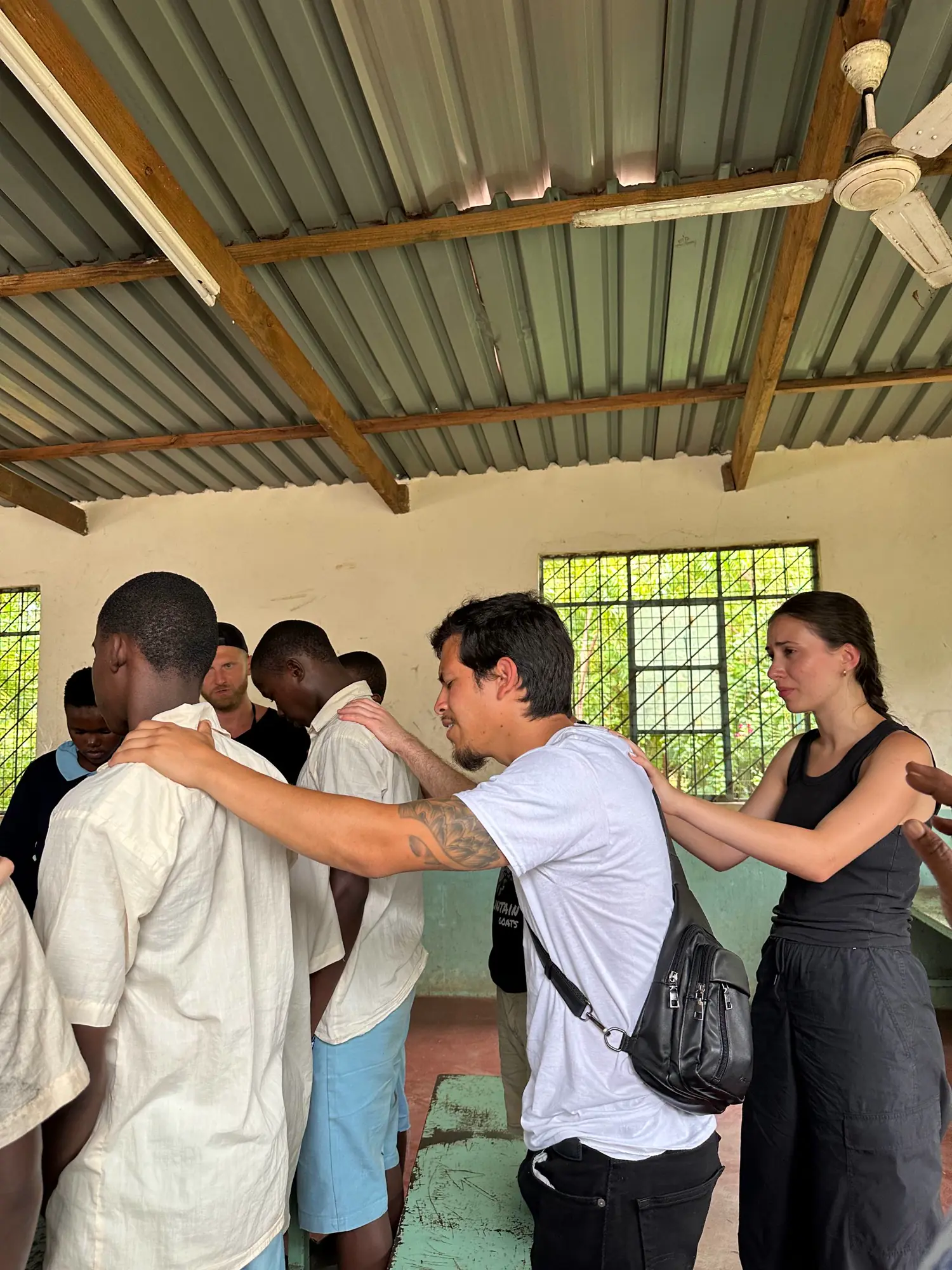 A team prays during a ministry visit at a juvenile detention center