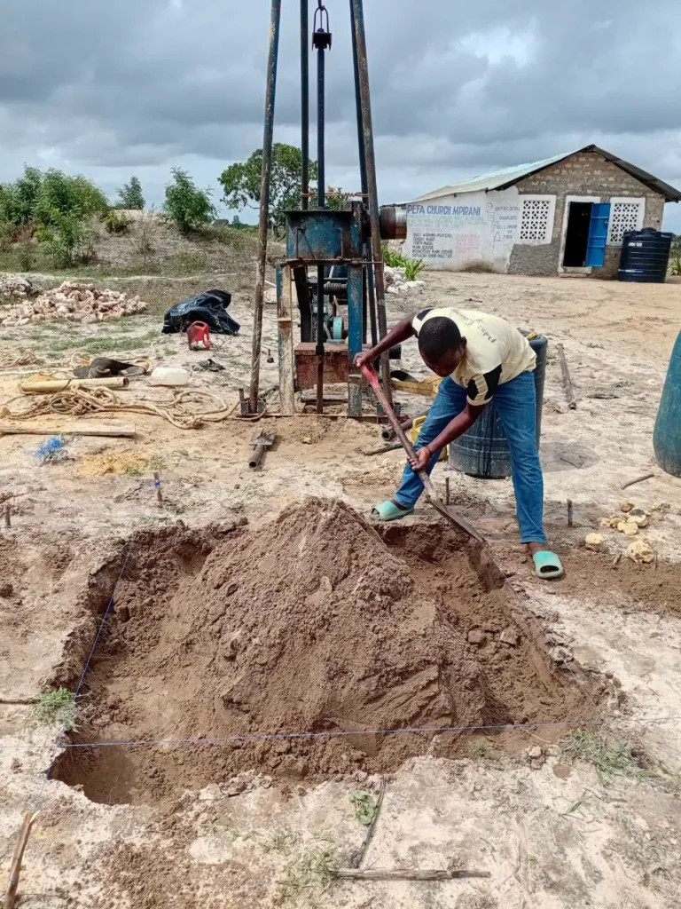 Team preparing a clean water well in Mpirani