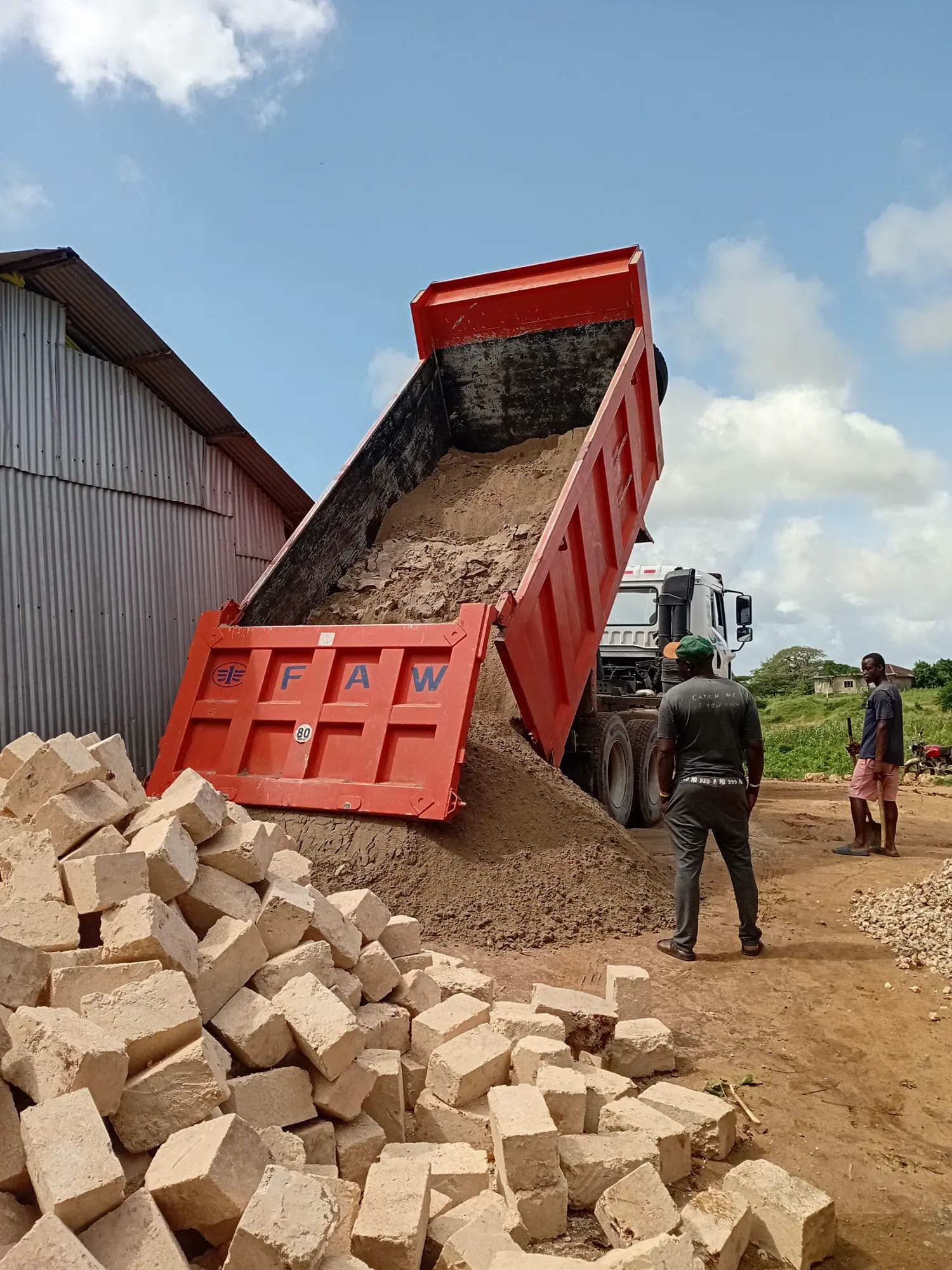 Construction materials and foundation work at a school project site