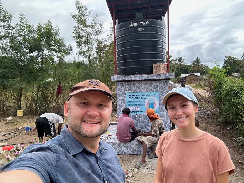 Bring Life Mission team conducting a final inspection of a new water well