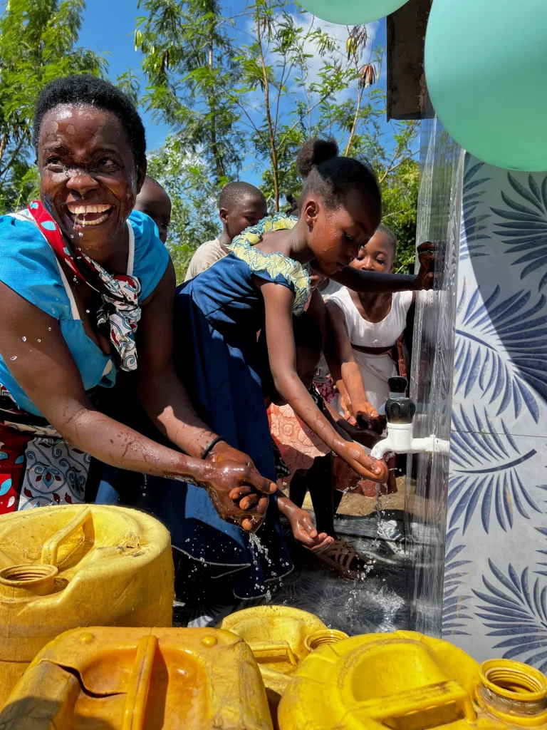 Joy at a well opening as families drink and wash with clean water